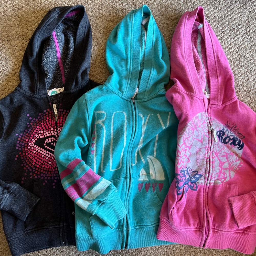 Three Roxy zip-up jackets with hoods.  Size girls small 7/8.